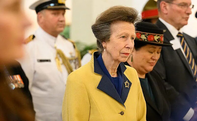 Princess Anne wore a red shirt dress and a beige tweed jacket and yellow and navy blue wool cashmere coat. Gold brooch