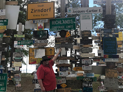 Paul put up our sign at the World Famous Sign Post Forest