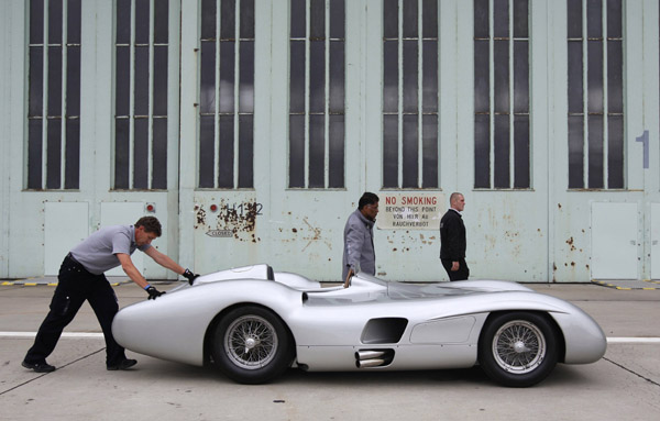 Mechanics push a W196 old timer racing car at a Mercedes Benz vintage car 