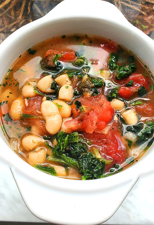 spinach and tomato white beans in a vegetable broth