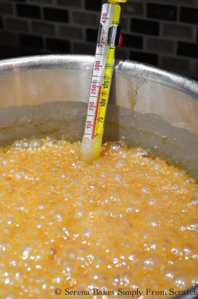 Apple Cider Caramel recipe bubbling with thermometer at 250 degrees.