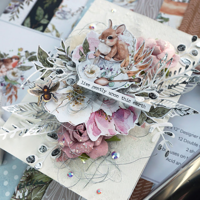 P13 Forest Tea Party mixed media panel with fussy cut paper ephemera, funky floral and skeleton leaves die cuts embellished with Scrapbook.com Smart Glue and Heidi Swapp Minc silver foil, Pinkfresh jewels, Prima Marketing flowers and impasto paint
