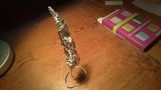 Using tin foil and wire support to form the core of the basilisk tooth. 