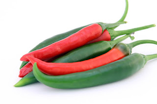 red and green peppers on a while background