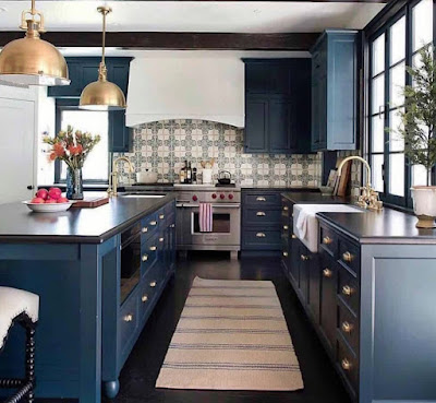 Dark blue cabinets with black countertops and mosaic pattern kitchen backsplash