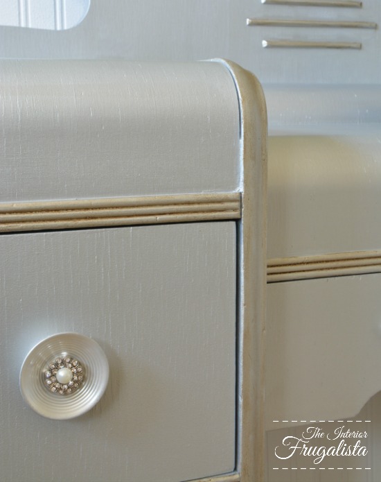 How to give a vintage waterfall vanity a drab to fab hollywood glam makeover with metallic paint, wrapping paper, and pearl embellished knobs.