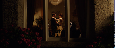 Constance and Charles seen dancing through a window in We Have Always Lived in the Castle