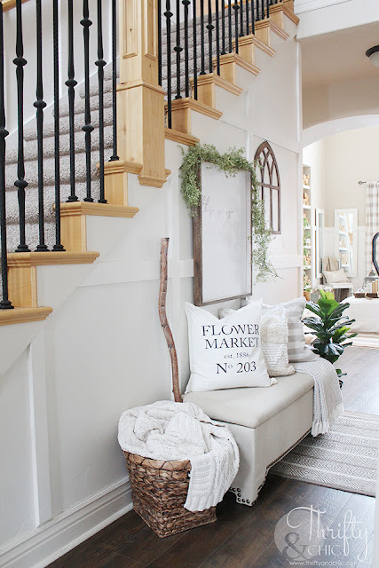 Spring entry way decor. How to decorate your stairs. Hallway decorating ideas. Spring decor and decorating ideas. Farmhouse spring decor. Easy spring decor. Entry way storage. Two story entry way with stairs.