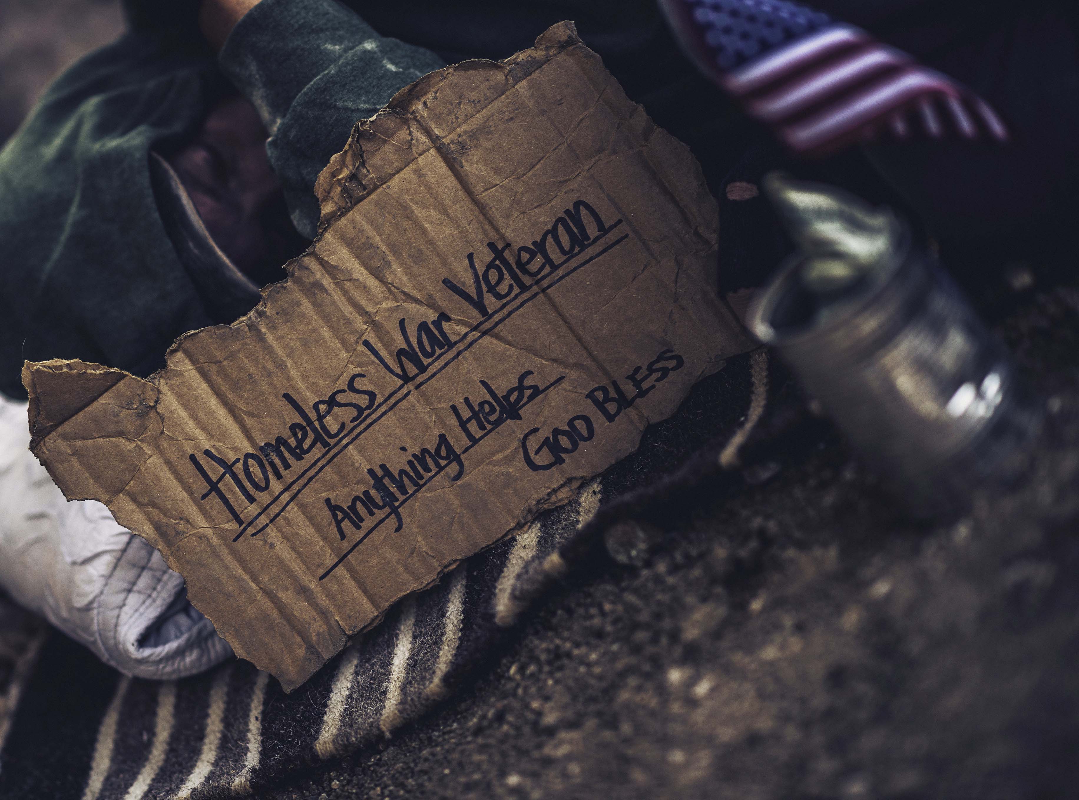 homeless veteran holding sign