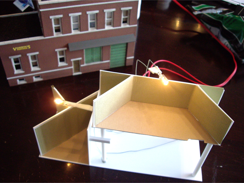 Scratch built removable interior showing a light bulb and electrical wiring for a DPM Cutting Scissor’s Co. kit