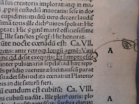 The margins of a printed page, with a drawn hand holding a string attached to one of the lines. 