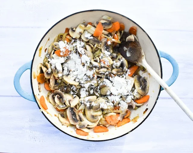 Mushroom Stew Step 5 - Flour (flour is scattered across the cooked vegetables)