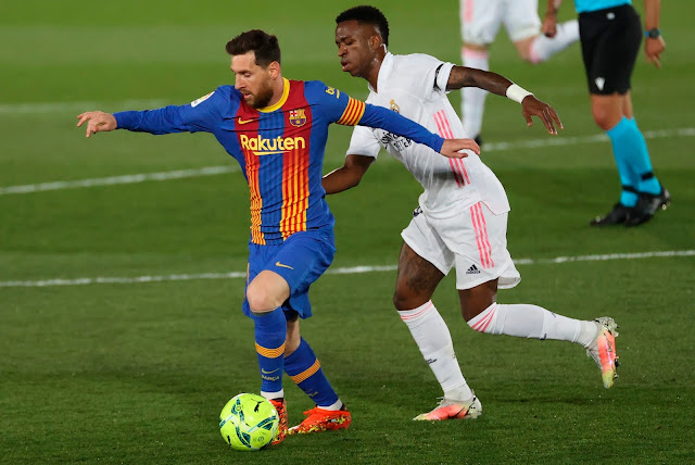 Barcelona forward Lionel Messi and Real Madrid forward Vinicius Jnr. during El Clasico match in La Liga