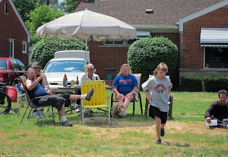 mullet kid and family enjoying parade, beer, smoking