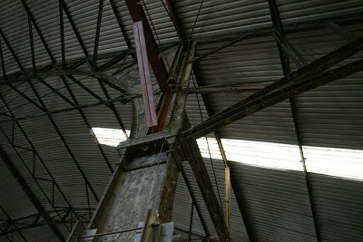 Interior photograph showing the roof including steel beams and struts and a corrugated iron roof.