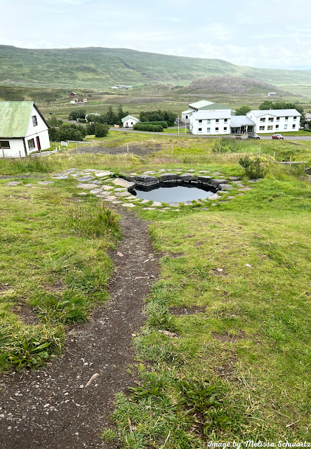 Guðrúnarlaug  Hot Pot sits behind Hotel Edda.