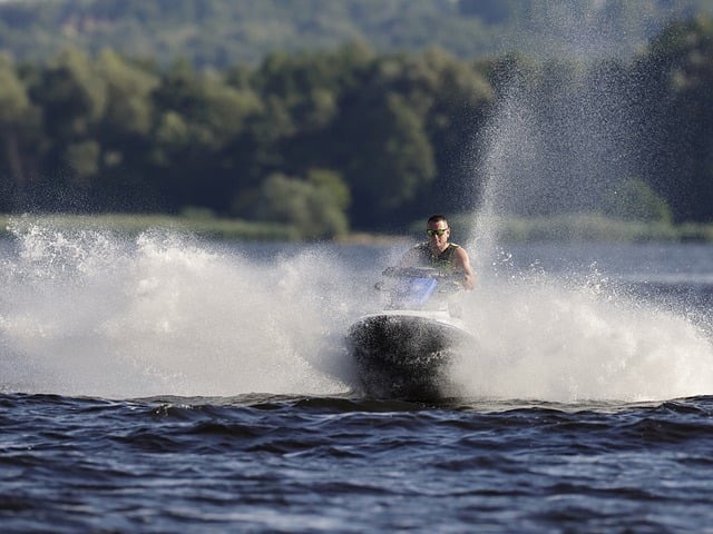 Man riding a jet ski waves