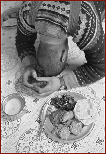 Offering prayer to Shri Krishna before having Mahaprasad