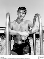 Rock Hudson on a swimming pool ladder