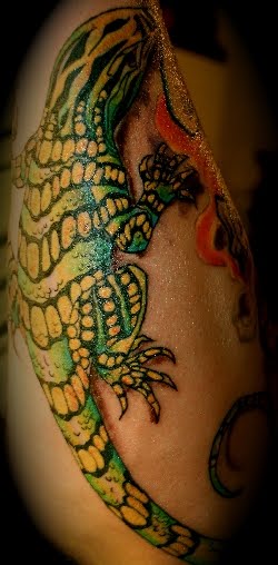The Lizard Tattoo for your arm is one choice if you like color tattoo for 