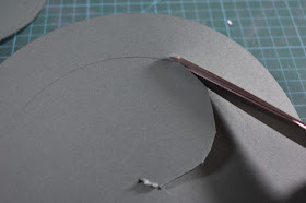 Put scissors in the hole made then cut upto inner circle