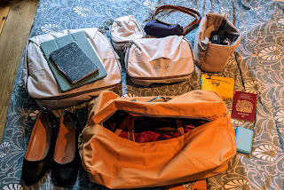 Millican Rucksack with packing cubes and other items to go into it, including shoes and iPad and Kindle