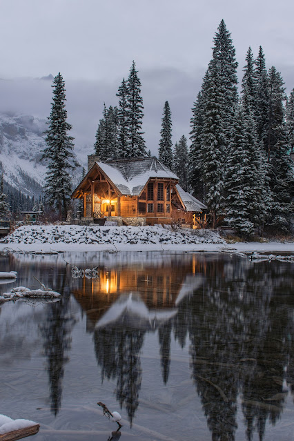 wooden house on lake in snow: Photo by Ian Keefe on Unsplash