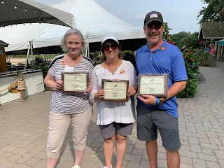 Corcoran Management Company employees posing with their 25 year plaques at Kimball Farm