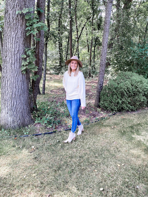 cream sweater with blue jeans and tan booties