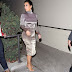 Kim wore an extra tight dress and tried to stop paparazzi from taking pics of her butt