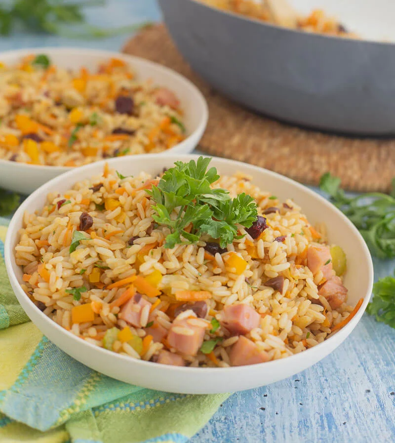 Cream serving bowls with servings of Christmas rice.