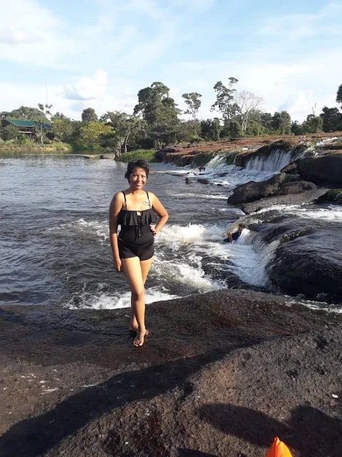 "Shachem Lieuw at Tap A Watra falls in the Amazon rainforest of Suriname"