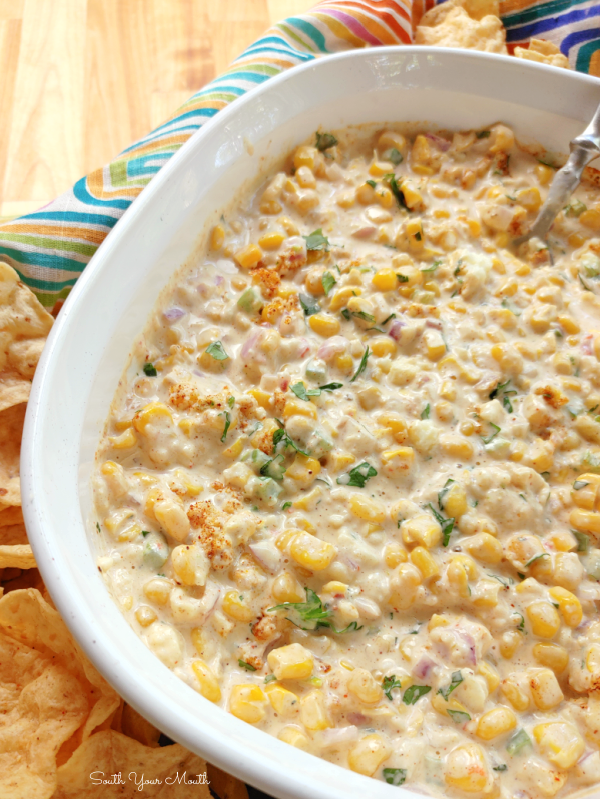 Crock Pot Mexican Street Corn Dip! A creamy, cheesy slow cooker party dip recipe with all the flavors of hot Mexican Street Corn served warm with tortilla chips.