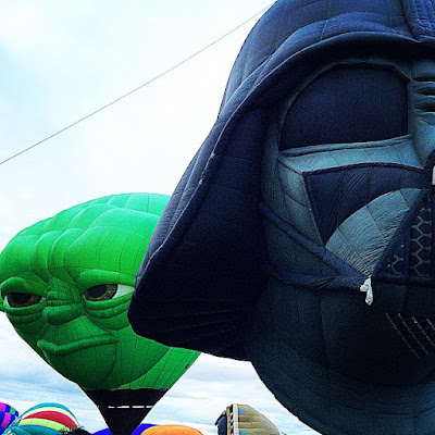 hot air balloons, two nearest are shaped like the heads of Yoda and Darth Vader