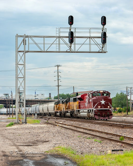 UP 1988 rolls by the cantilever signal bridge at Thereasa Ave, east of Grand Interlocking