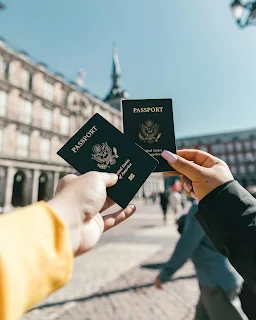 Photo by Spencer Davis: https://www.pexels.com/photo/anonymous-tourists-showing-us-passports-on-street-on-sunny-day-4353813/