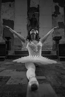 Ballerina in the splits in an abandoned building