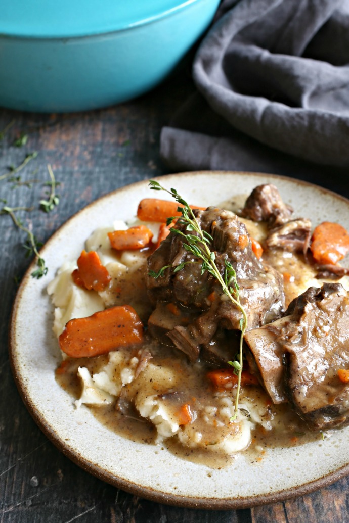 Recipe for short ribs braised in red wine, beef stock, vegetables and thyme.