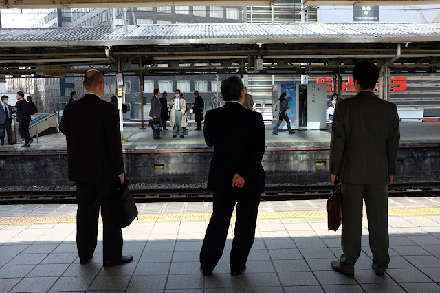 Japanese salaryman photo suits train station