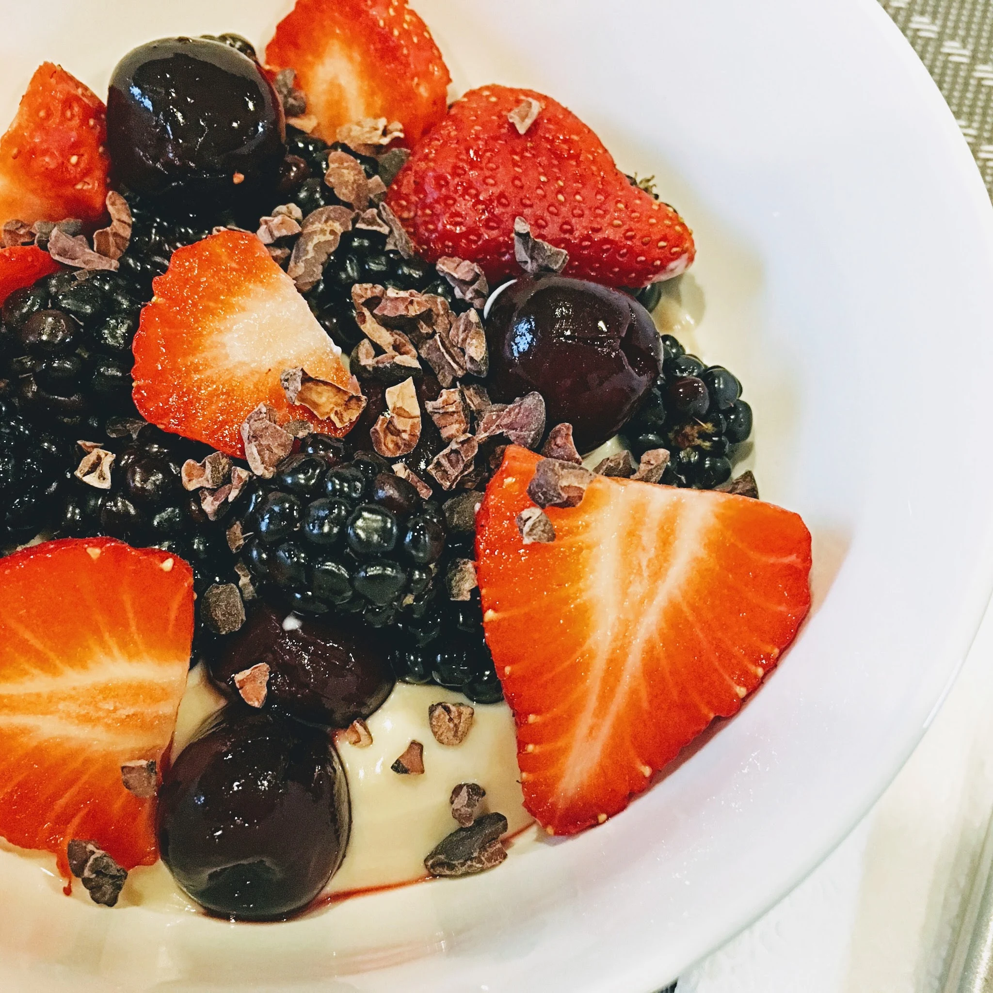 Quick and Healthy Breakfast with Greek Yogurt, Fresh Fruit and Cacao Nibs.  Decadent and delicious, full of healthy nutrients and protein. | www.livingyoungandhealthy.com