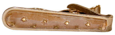 A vintage man's tie clip in gold, with small gold stars on the face.