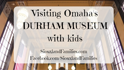 in background, art deco style grand hall of Omaha's Union Station, in foreground "visiting Omaha's Durham Museum with kids"