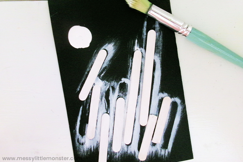 paint craft sticks for skeleton craft