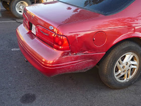 Large dent in bumper and quarter panel on 1996 Ford Thunderbird