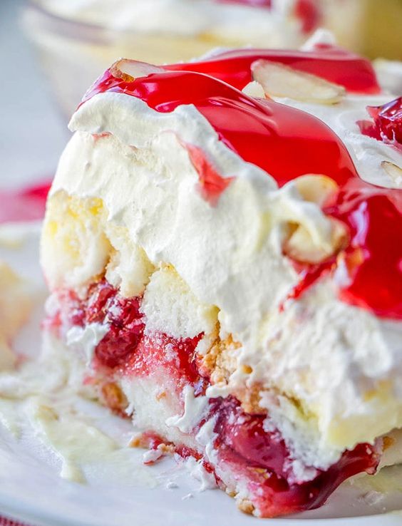 Angel Food Cake trifle with cherry filling, vanilla, pudding, whipped topping and almonds for a creamy, decadent dessert everyone will love! Perfect for potlucks or parties.