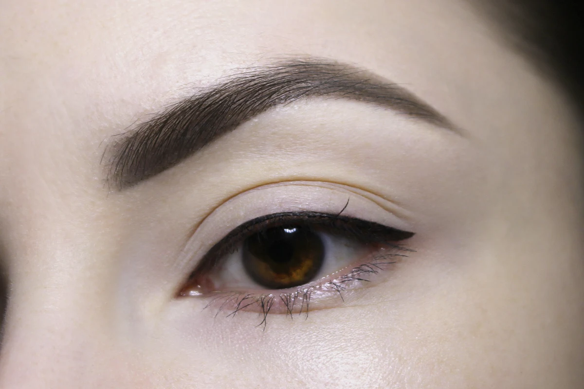 close-up shot od woman's eye with a hooded eyelids and small eyeliner wing