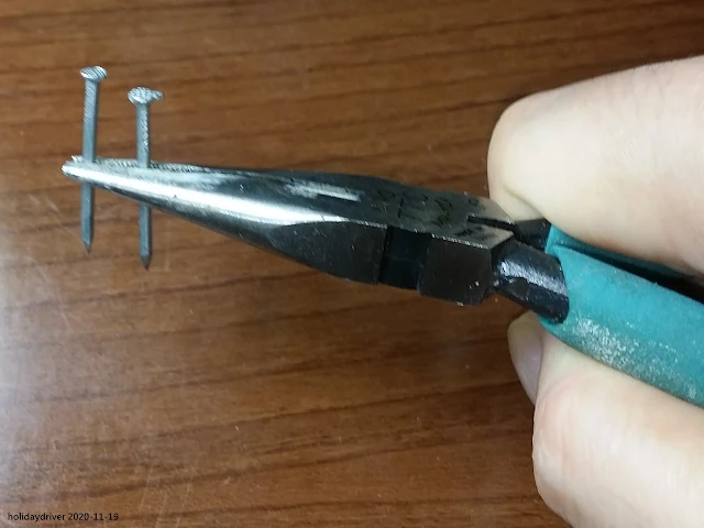 Sharp nose pliers with two nails