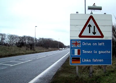 A road sign about drive on the left