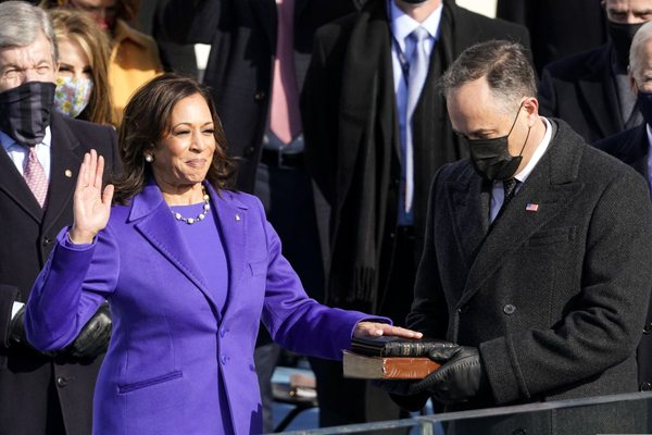 With her husband Doug Emhoff holding two Bibles, Kamala Harris takes the oath of office as she is sworn in as the 49th Vice President of the United States...on January 20, 2021.