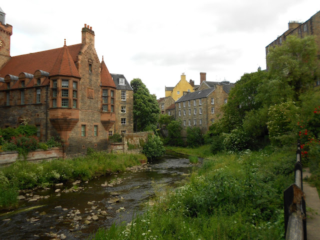 A picture of the river, The Water of Leith, and historic buildings.